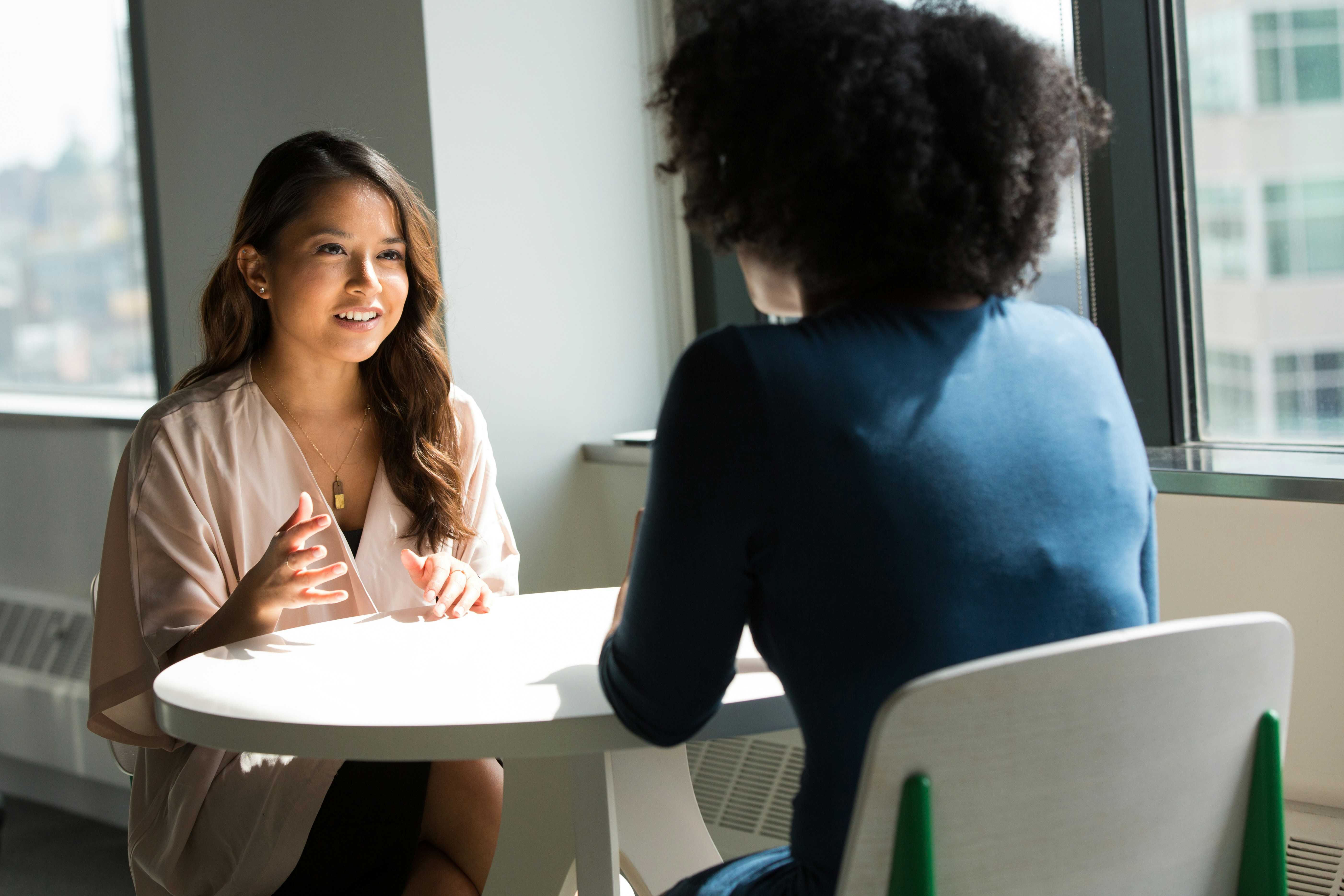Diverse coaching conversation in business casual setting
